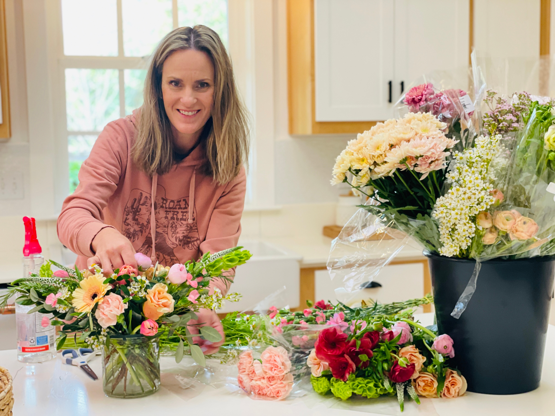 Jessie at her kitchen island arranging fresh flowers